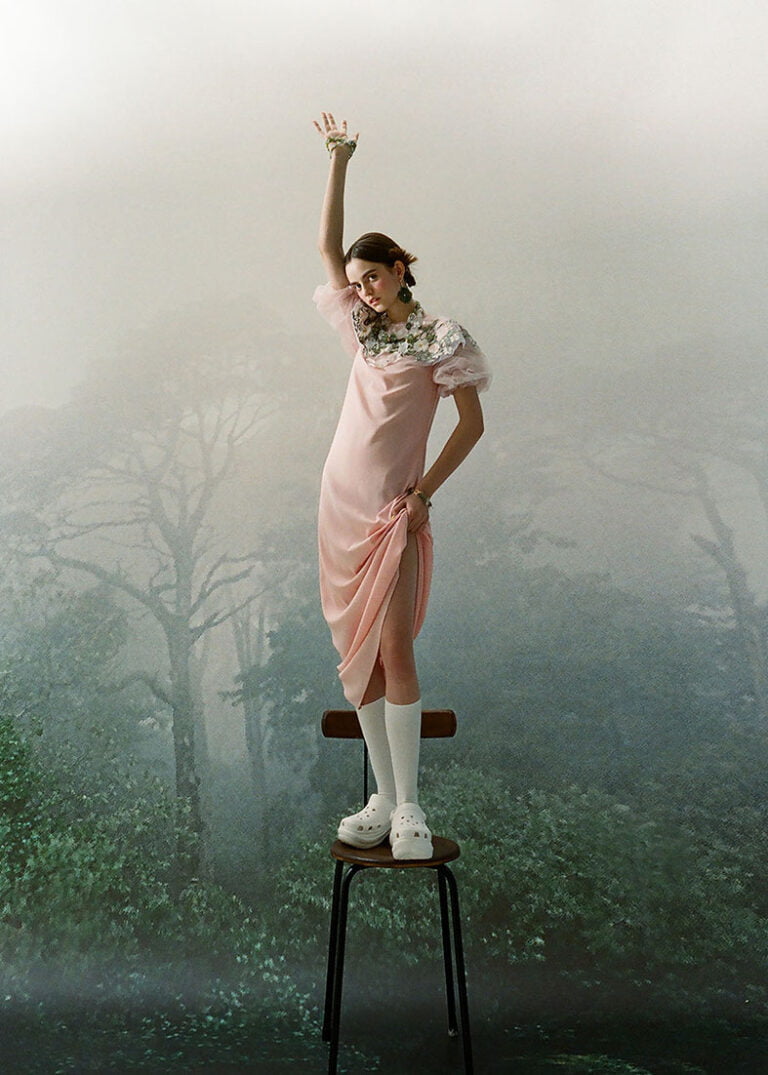 Model in a pink dress is standing on a chair. TATYANA PARFIONOVA x NADJIA AZENET JEWELLERY