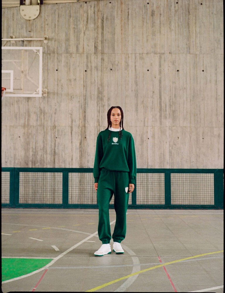 A young woman wearing green sportswear in a gym. DUB / editorial SS 2023 by photographers: Xavier Carpio, Tai Cruz, Yulia Plakhotnikova