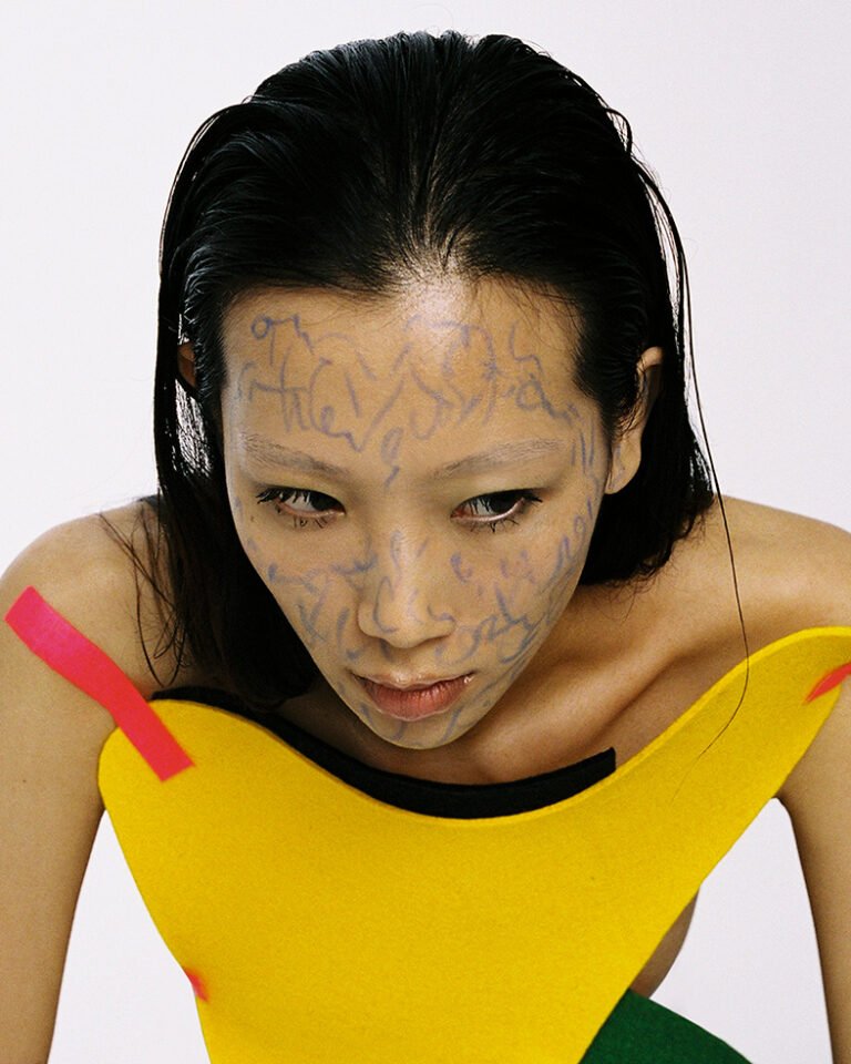 Portrait of a beauty model with doodles on her face