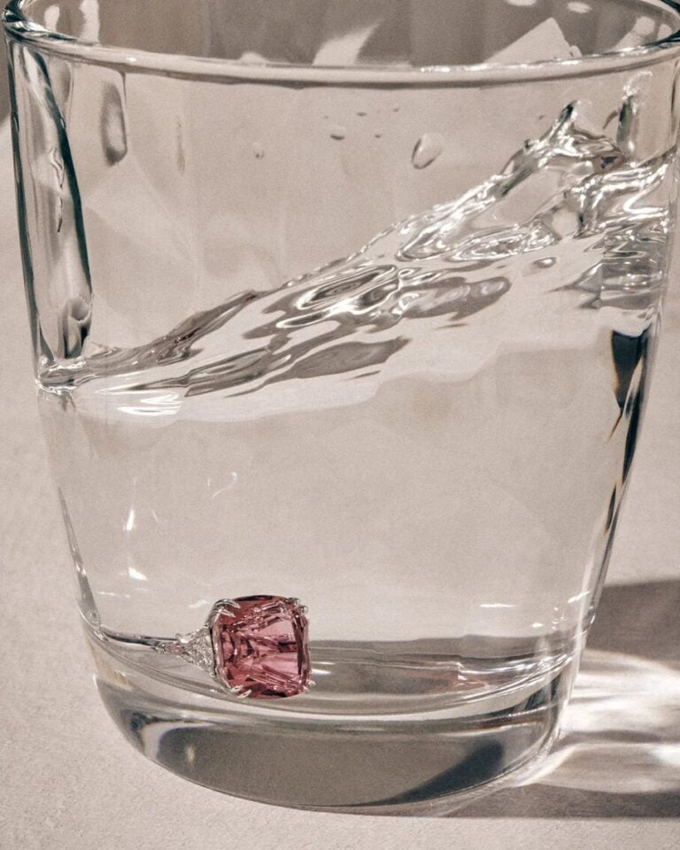 Timeless Tourmaline Ring with a pink stone in a glass full of water. Jewellery photography.