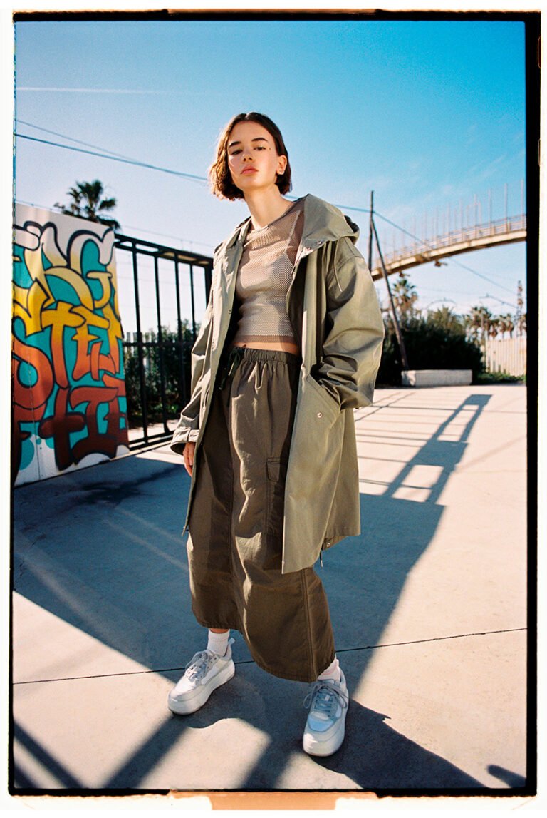 A young girl outdoors wearing sportswear.