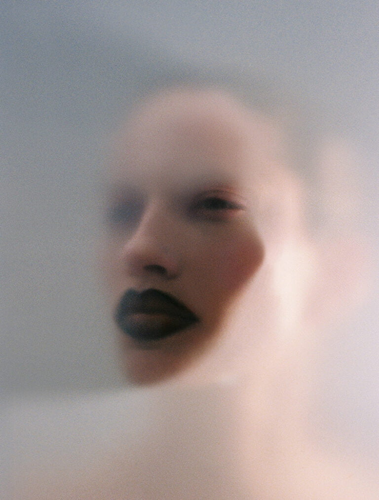 Portrait of a model through matt glass