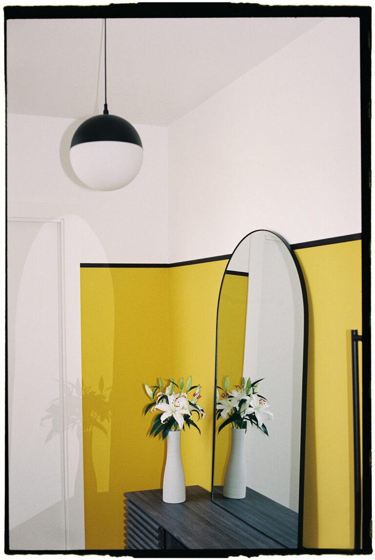 Interior with a mirror and yellow walls. Interior photography.