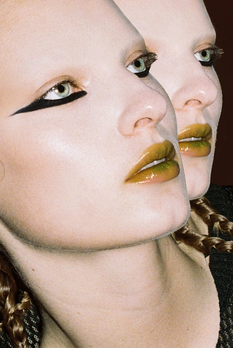 Portrait of a makeup model with her face displayed twice.