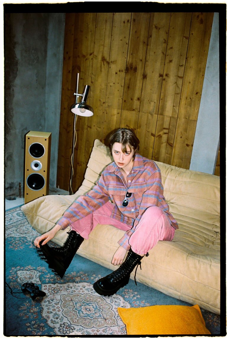 A young female model sitting on a couch