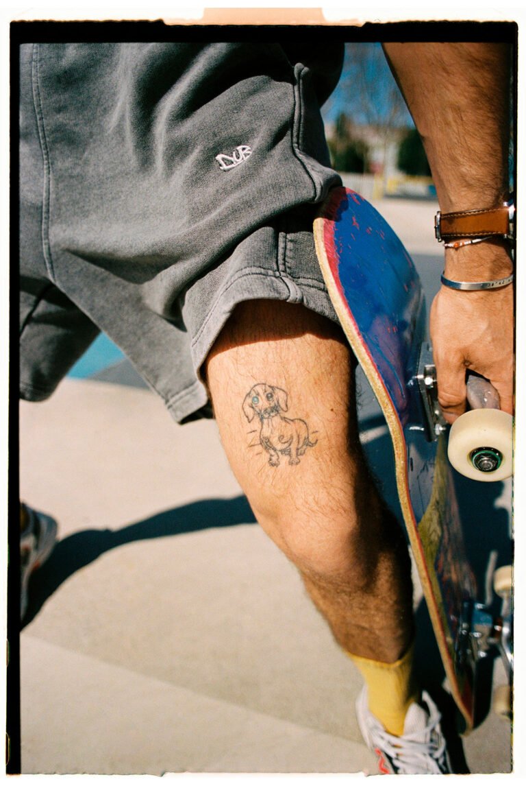 Close up of a tattoo on a skater's leg. Urban fashion.