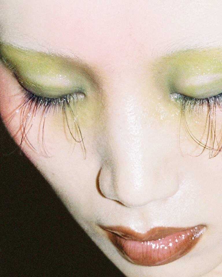 Close-up of a makeup model's face with her eyes closed