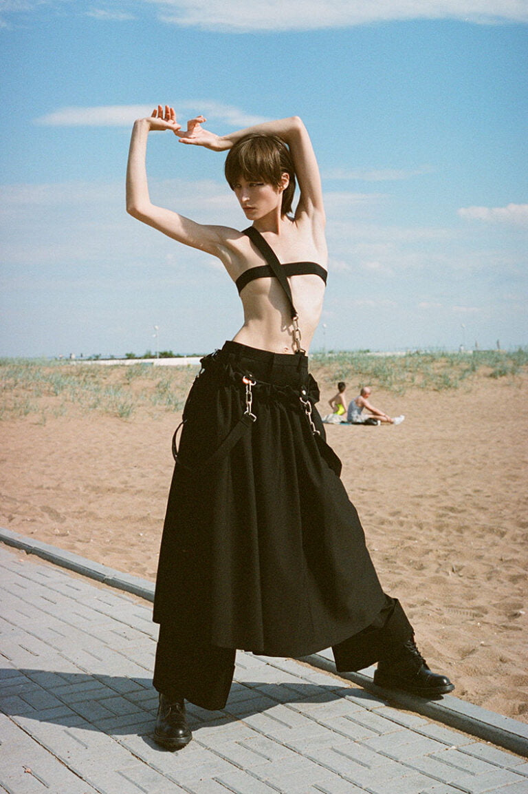 Photograph of a fashion model at the beach.