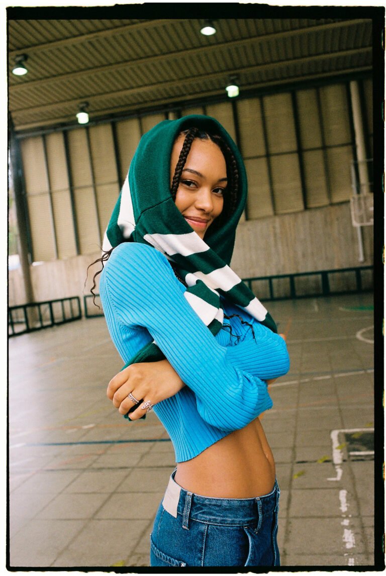 A young woman in a gym wearing sportswear