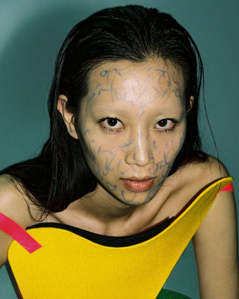 Portrait of a makeup model with doodles on her face