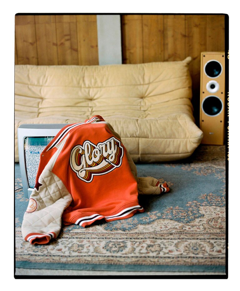 Bomber jacket on top of a tv