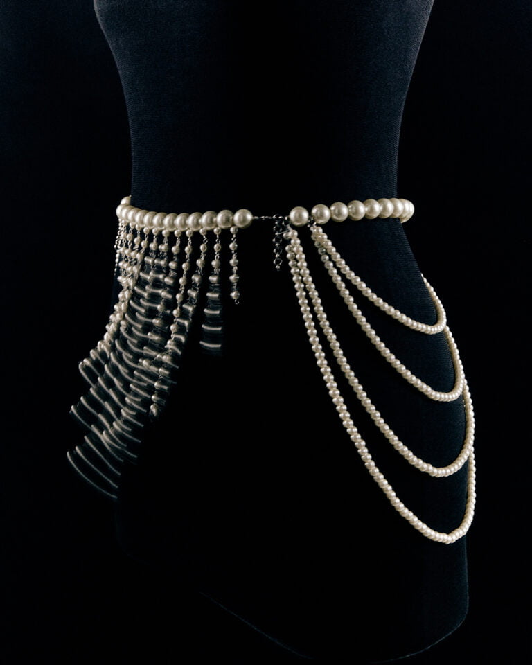 Piece of jewellery with pearls on black velvet mannequin