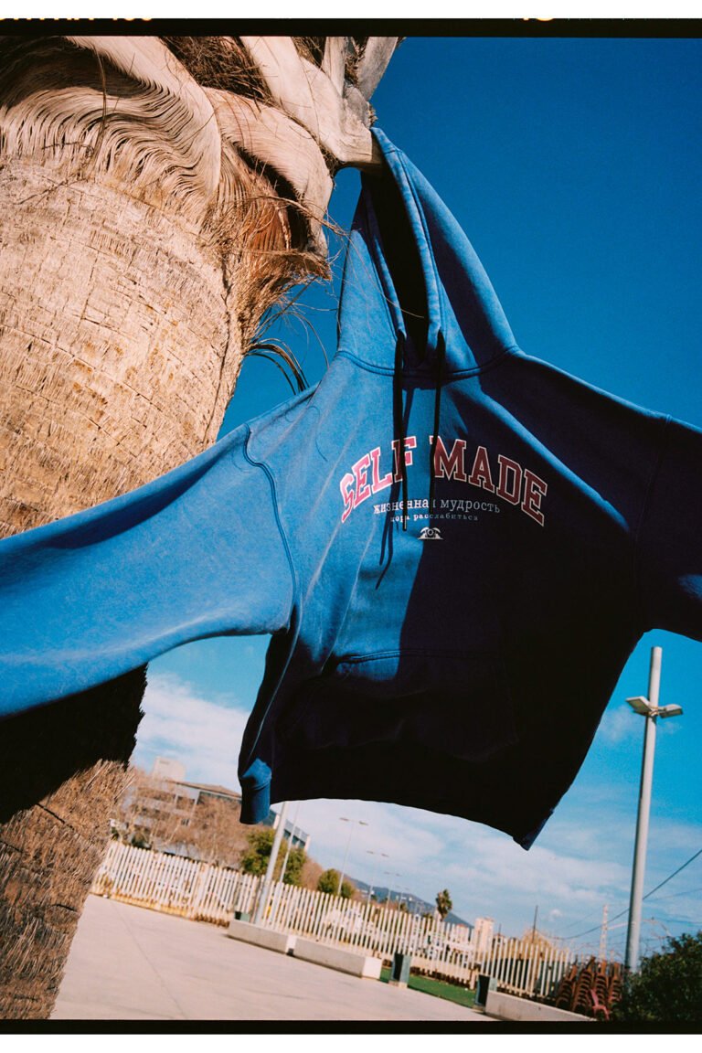 Blue sport hoodie hanging of a palm tree