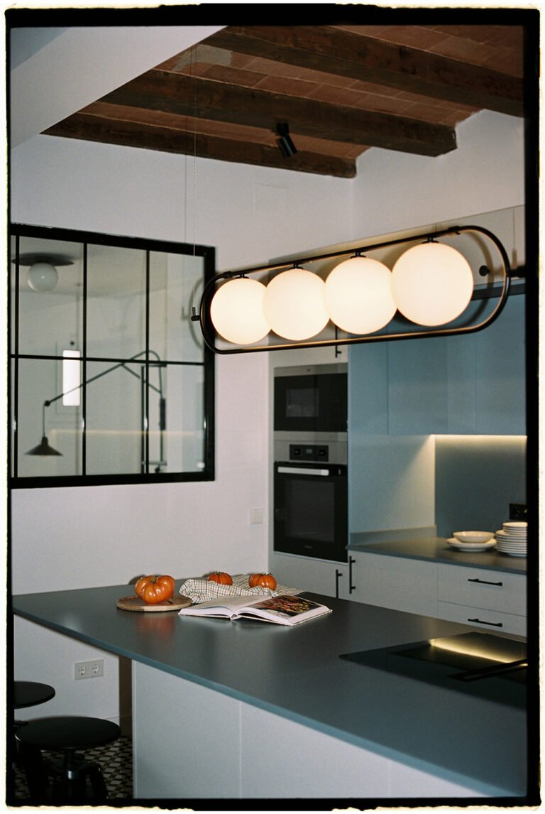 Kitchen lights that look like a row of four white balls. Kitchen interior.