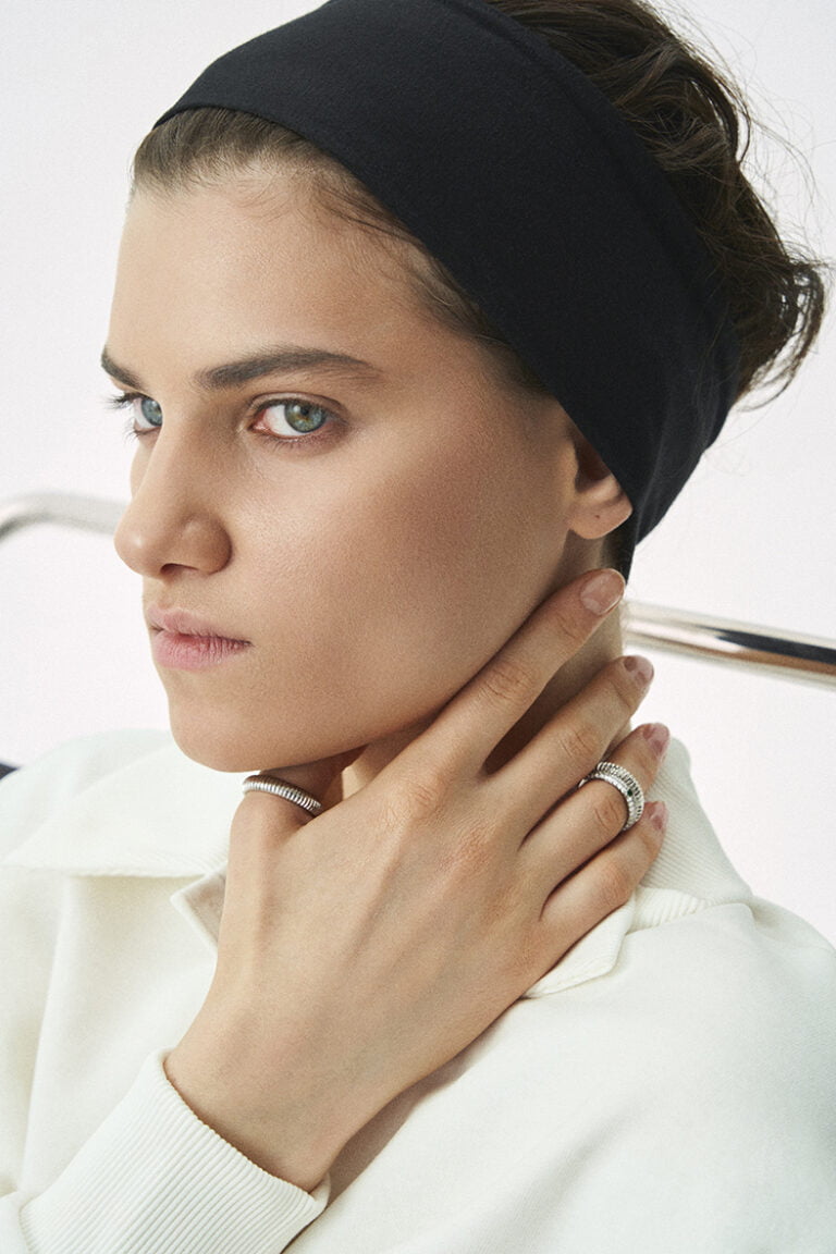 Portrait of a model with rings on her fingers.