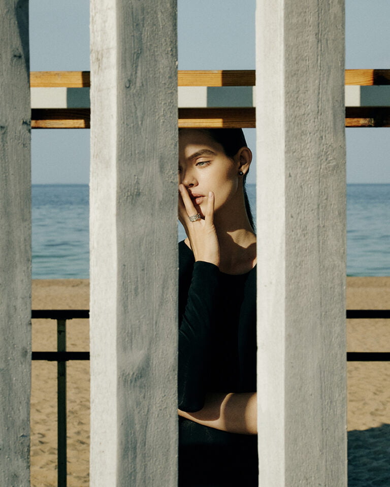 Photograph of a model at the beach with a ring on her finger